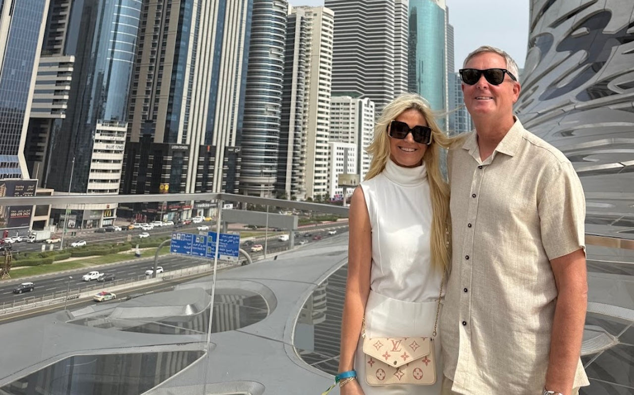 Couple standing in front of Dubai’s futuristic city skyline