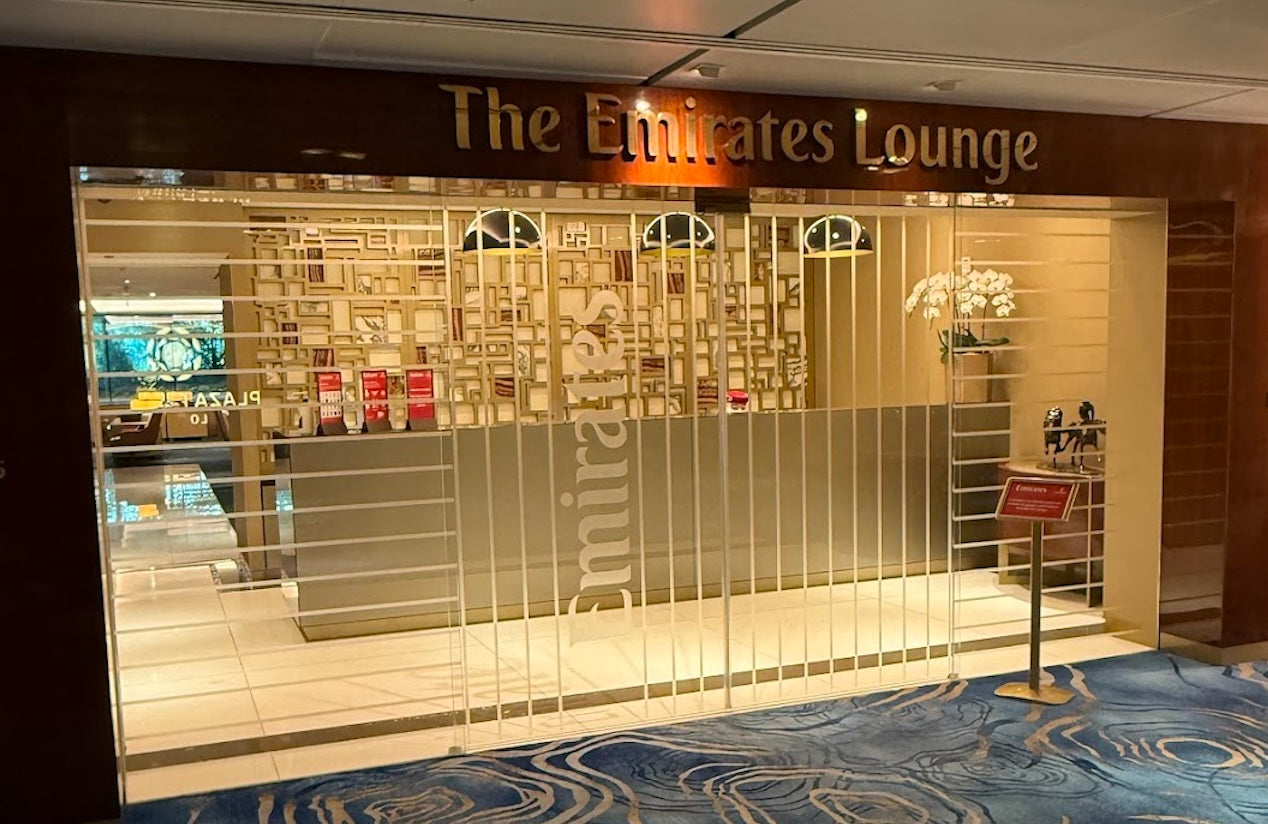 Entrance to The Emirates Lounge with gold signage and upscale interior decor