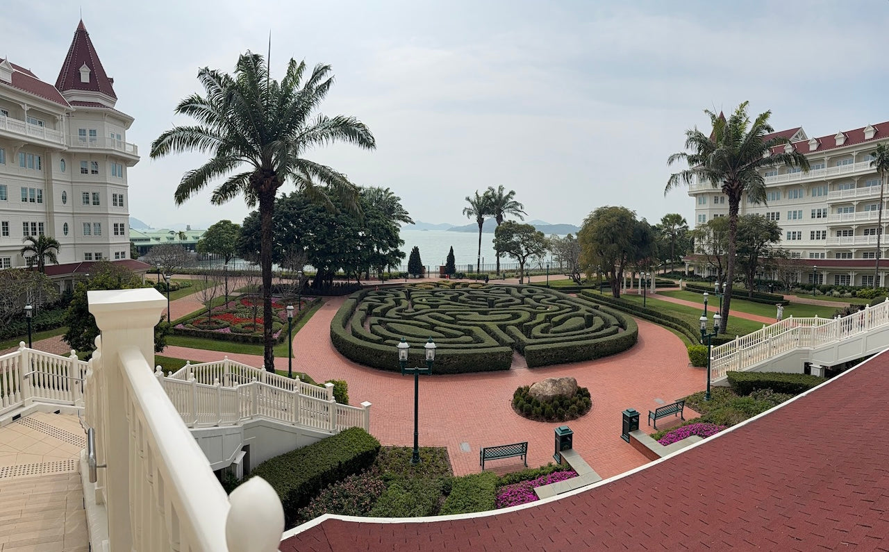 Victorian-style hotel overlooking a manicured garden maze and ocean view at Hong Kong Disneyland Hotel