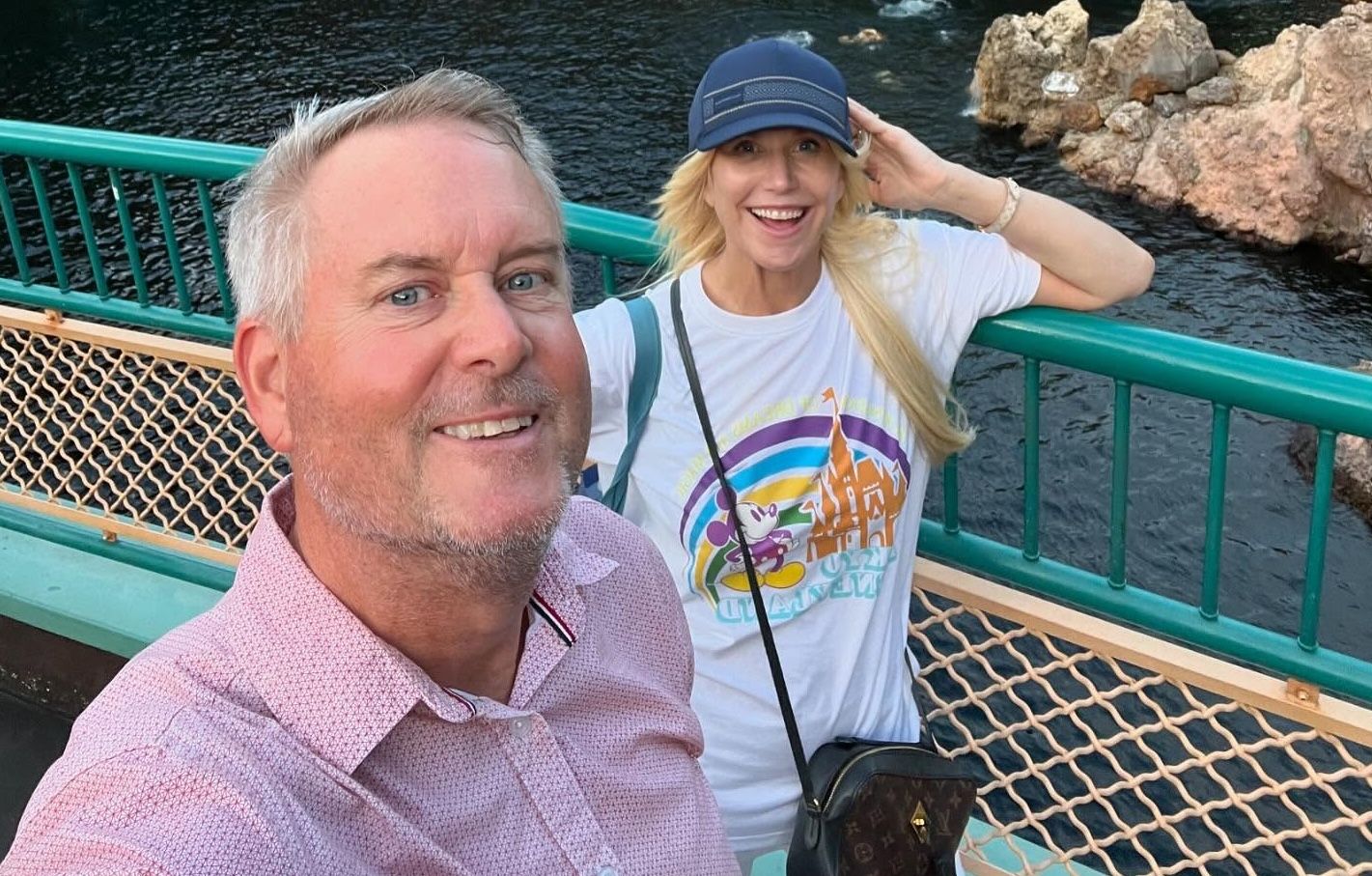 Brian and Teresa taking a selfie with smiles near water and rock formations at Tokyo DisneySea.