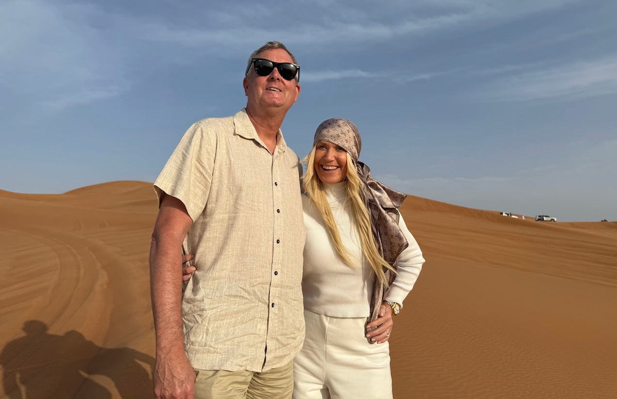 Couple standing in the Dubai desert during a golden-hour safari